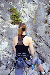Woman preparing to climb a rock wall - LMF00662