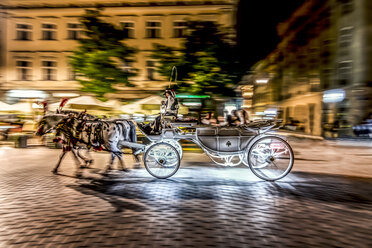 Polen, Krakau, Altstadt, Hauptplatz, Kutsche in Bewegung bei Nacht - CSTF01243