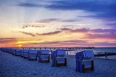 Germany, Kuehlungsborn, sea bridge and beach chairs at sunrise - PUF00591