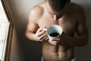 Attractive young amn with six pack drinking coffee - KKAF00482