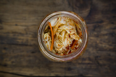 Glass of Kimchi on dark wood - LVF05887