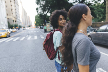 USA, New York City, two friends crossing the street - GIOF01969