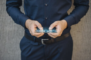 Businessman using futuristic portable device - KNSF01059