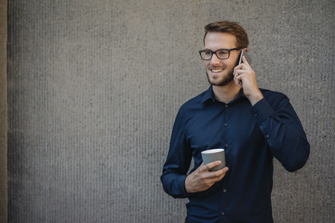 Smiling businessman talking on cell phone stock photo