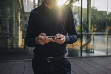 Businessman using futuristic portable device - KNSF01084