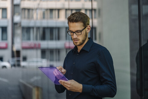 Businessman using futuristic portable device - KNSF01110