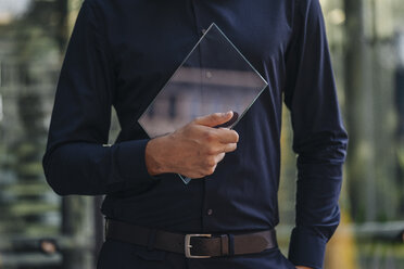 Businessman holding futuristic portable device - KNSF01113