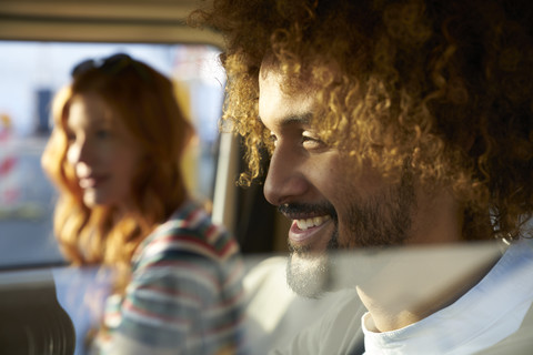 Smiling young man with girlfriend in a car stock photo