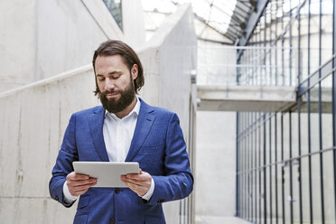 Businessman using tablet - FMKF03550