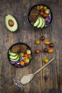Lunch bowls of leaf salad, red cabbage, avocado, tomatoes and quinoa fritters - LVF05895