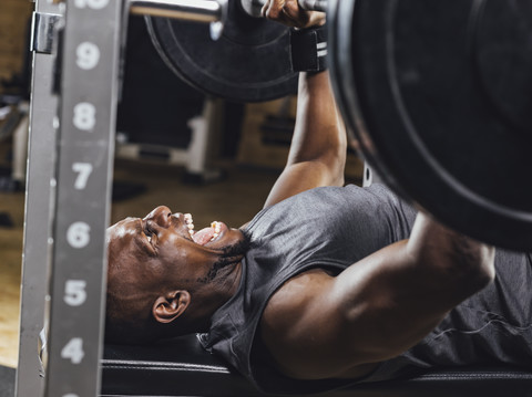 Sportler im Fitnessstudio beim Gewichtheben, lizenzfreies Stockfoto