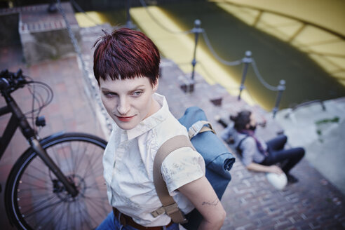 Germany, Hamburg, portrait of woman with dyed hair and backpack - RORF00674