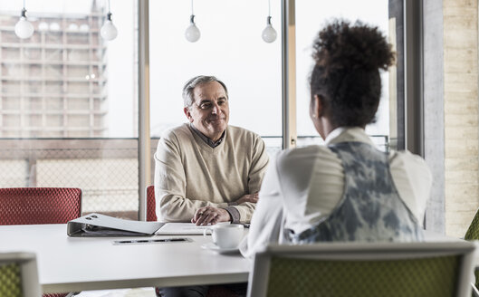 Businessman and young woman in conference room - UUF10034