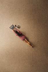 Woman lying on carpet using laptop, top view - JOSF00631