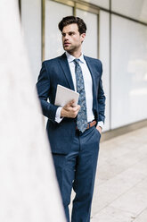 Handsome businessman using digital tablet - GIOF02052
