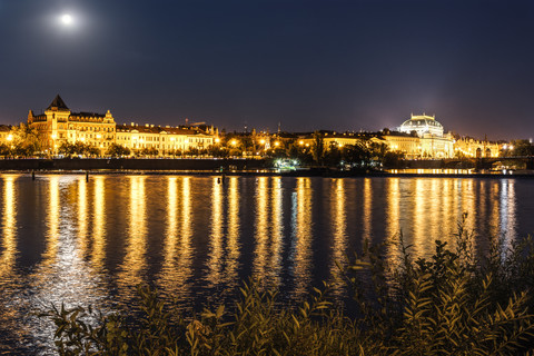 Czechia, Prague, view to National theatre with Vltava in the foreground at night stock photo