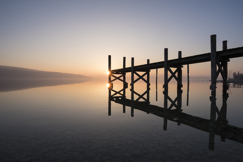 Germany, Reichenau Island, wooden boardwalk at twilight stock photo