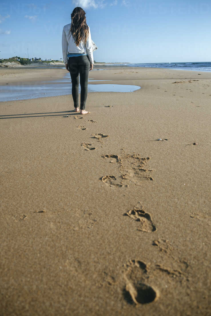 Woman at Beautiful Beach. Focus on Footprints. Stock Photo - Image