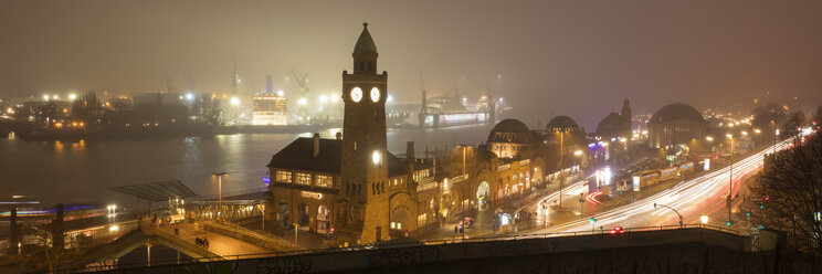 Germany, Hamburg, panoramic view of St. Pauli Landing Stages with port in the background at night - WIF03409