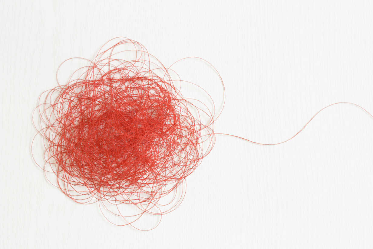 Red thread on white background stock photo