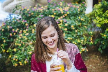 Young woman in Sevilla drinking fruit juice - KIJF01337