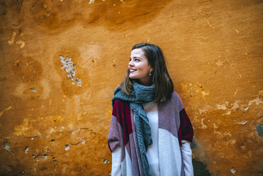 Young woman in front of house wall - KIJF01350