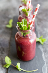 Beet root smoothie in glasses garnished with fresh mint - SARF03245