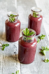 Beet root smoothie in glasses garnished with fresh mint - SARF03246