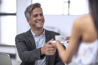 Businessman in office getting a cup coffee - ZEF13068