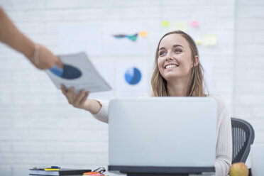 Young woman working in office taking documents - ZEF13084