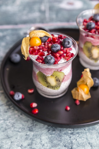 Glass of chia pudding with several fruits stock photo