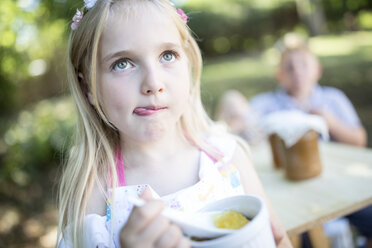Girl eating jelly outdoors - WESTF22783