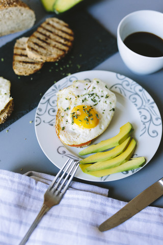 Breakfast with eggs, avocado, bread and coffee stock photo