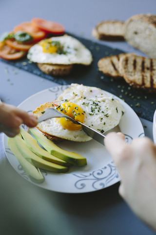 Breakfast with eggs, avocado, bread and tomatoes stock photo