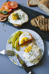 Breakfast with eggs, avocado, bread and tomatoes - GIOF02158