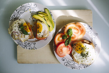 Delicious eggs with tomatoes and avocado on the table - GIOF02166