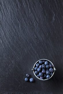 Pail of blueberries on slate - CSF27969