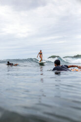 Indonesia, Java, surfers in the ocean - KNTF00707