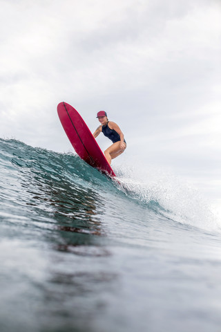Indonesia, Java, woman surfing stock photo