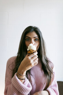 Junge Frau isst eine Torte mit Schlagsahne - VABF01237