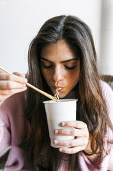 Young woman eating Chinese noodles - VABF01246
