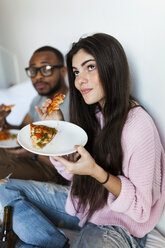 Young couple sitting at home eating pizza - VABF01249