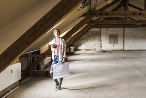 Young woman contemplating the renovation of her new home - UUF10086