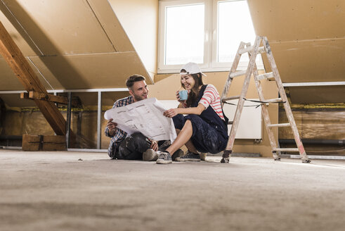 Young couple on construction site of theit new home - UUF10105