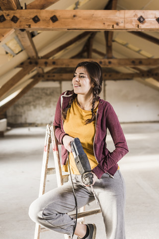 Independent young woman renovating her new home stock photo