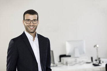 Portrait of a young businessman in his office - SBOF00370