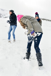 Three friends having fun in the snow - MGOF03029