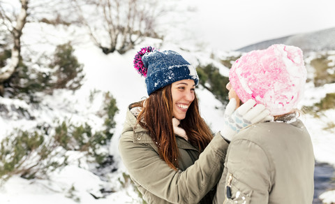 Zwei Freunde haben Spaß im Schnee, lizenzfreies Stockfoto