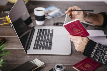 Man holding passport planning a trip - JRFF01252