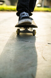 Feet of a skateboarder on a skateboard - KKAF00519